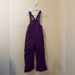 Insulated bib snow pants with reinforced knees and seat. Waterproof Windproof